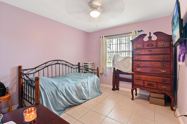 tiled bedroom with ceiling fan and a textured ceiling