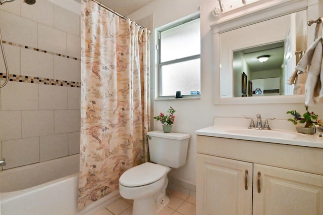 full bathroom featuring toilet, vanity, tile patterned flooring, and shower / bath combo with shower curtain