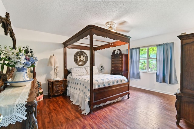 bedroom with ceiling fan, dark hardwood / wood-style floors, and a textured ceiling