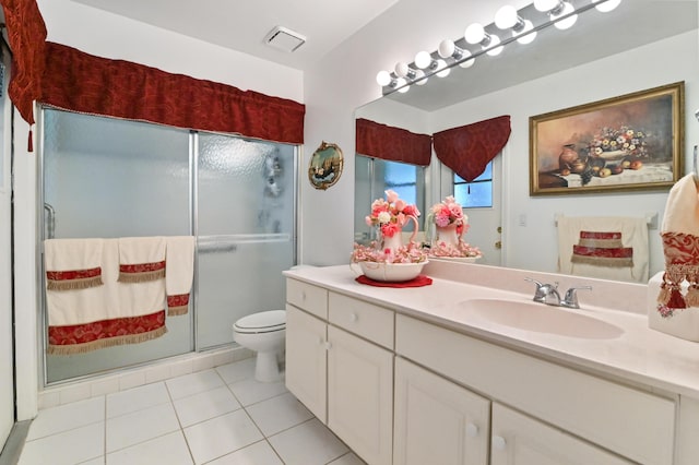 bathroom featuring vanity, toilet, tile patterned floors, and a shower with door