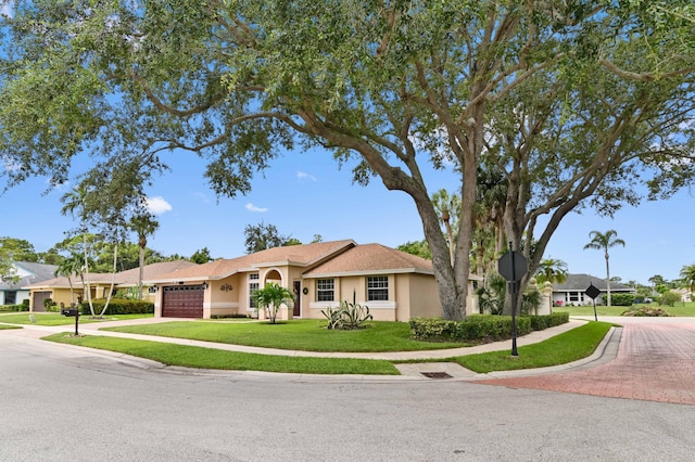 view of front of house with a front lawn and a garage