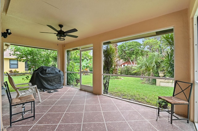 unfurnished sunroom with ceiling fan