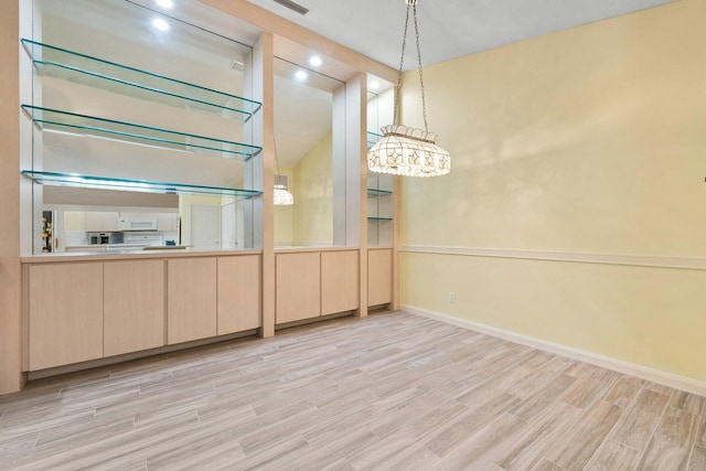 1217 NW Sun Terrace Cir Unit B, Port Saint Lucie, FL 34986 - unfurnished dining area featuring baseboards and wood finished floors