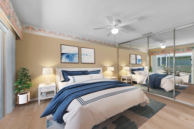1217 NW Sun Terrace Cir Unit B, Port Saint Lucie, FL 34986 - bedroom featuring wood finished floors, a closet, a textured ceiling, ceiling fan, and baseboards