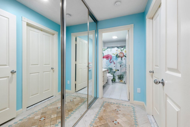 1217 NW Sun Terrace Cir Unit B, Port Saint Lucie, FL 34986 - bathroom with tile patterned flooring, baseboards, toilet, and a shower with shower curtain