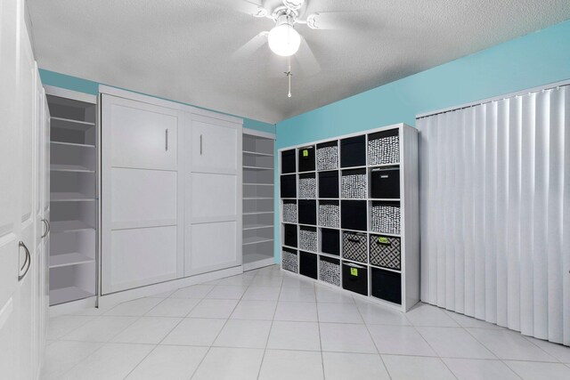 interior space featuring ceiling fan and a textured ceiling