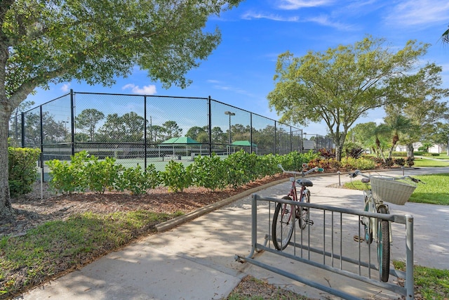 view of property's community with tennis court