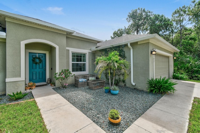 doorway to property with a garage