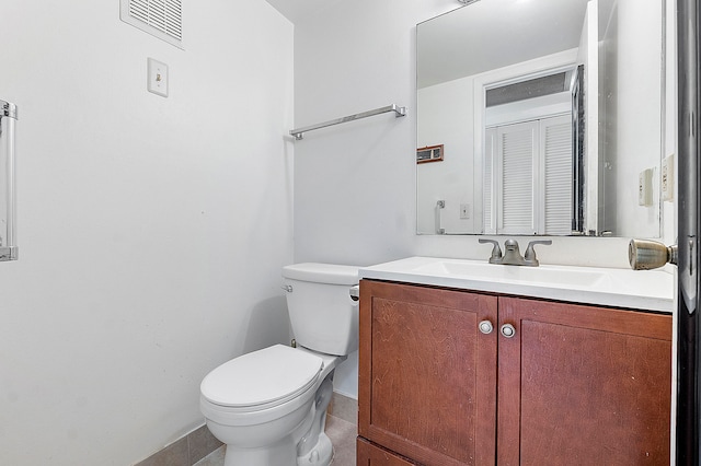 bathroom with vanity, toilet, and tile patterned flooring