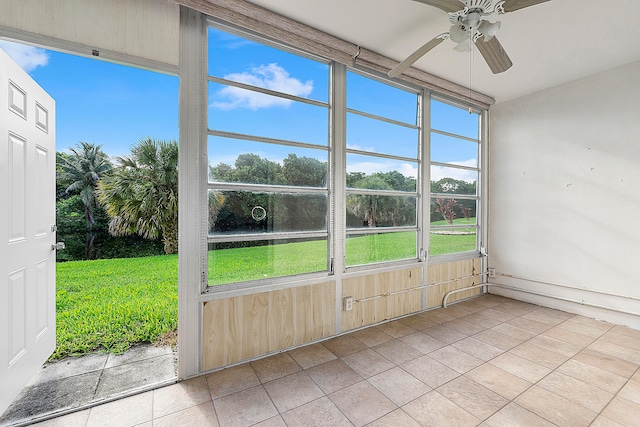 unfurnished sunroom featuring ceiling fan