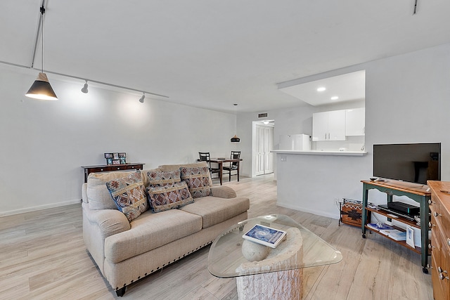 living room featuring light hardwood / wood-style floors and track lighting