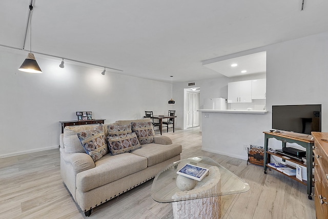 living room featuring track lighting and light hardwood / wood-style flooring