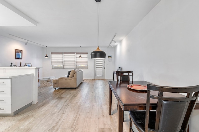 dining area featuring light hardwood / wood-style floors and rail lighting