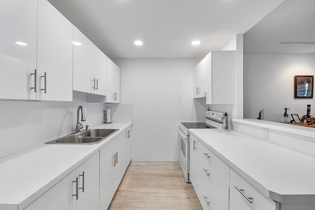 kitchen with sink, white cabinetry, double oven range, and light wood-type flooring