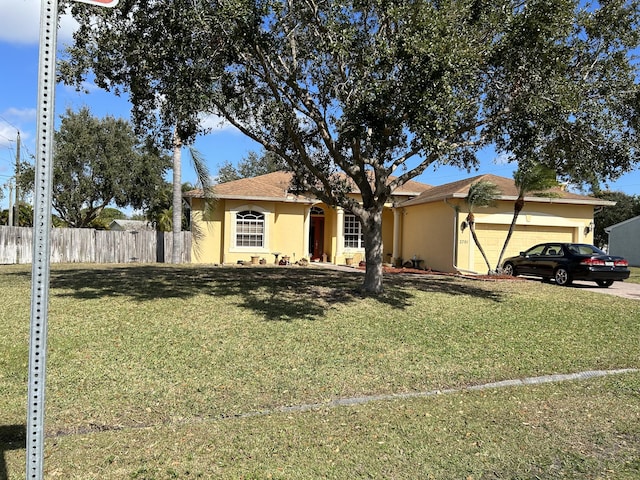 ranch-style home with a front yard and a garage