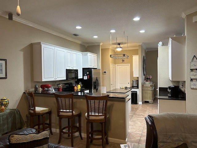 kitchen with kitchen peninsula, crown molding, black appliances, light tile patterned floors, and white cabinets