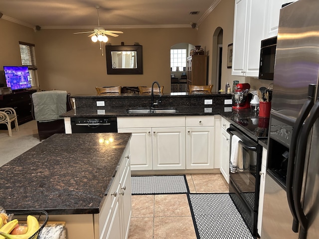 kitchen featuring ornamental molding, dark stone counters, sink, black appliances, and white cabinets