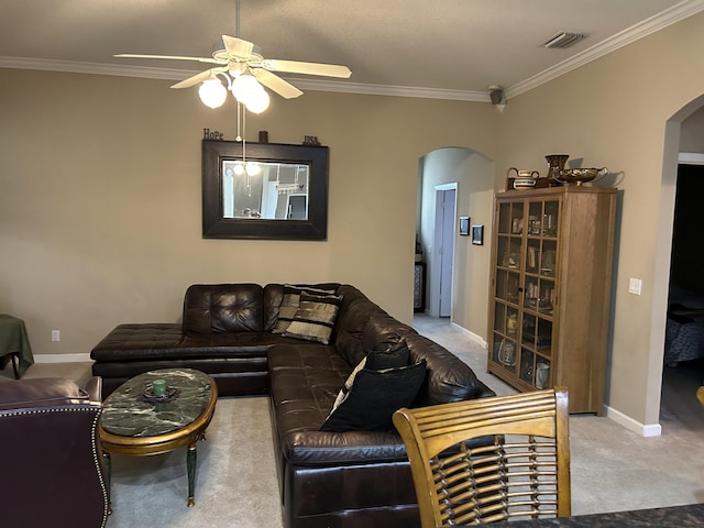 carpeted living room with ceiling fan and ornamental molding