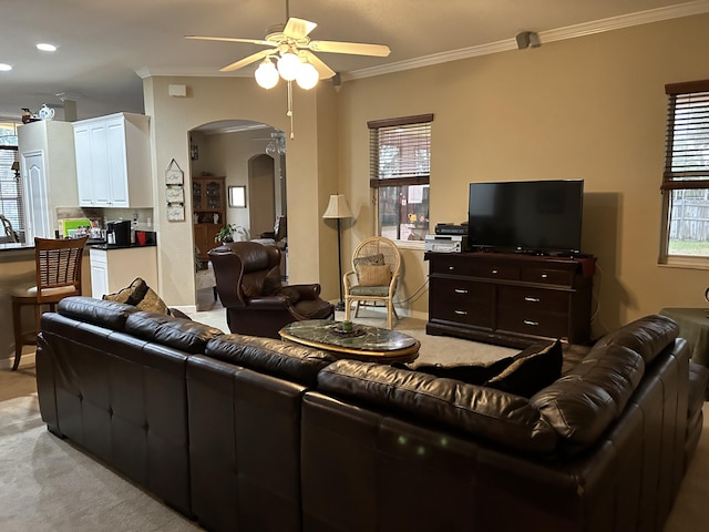 living room with ceiling fan, light carpet, and ornamental molding