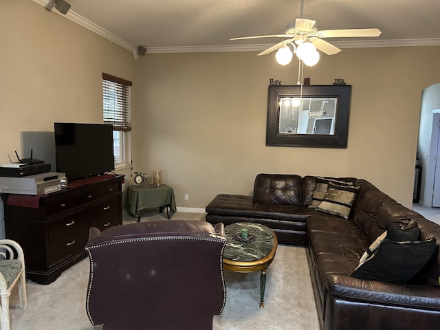 living room featuring ceiling fan, light colored carpet, and crown molding