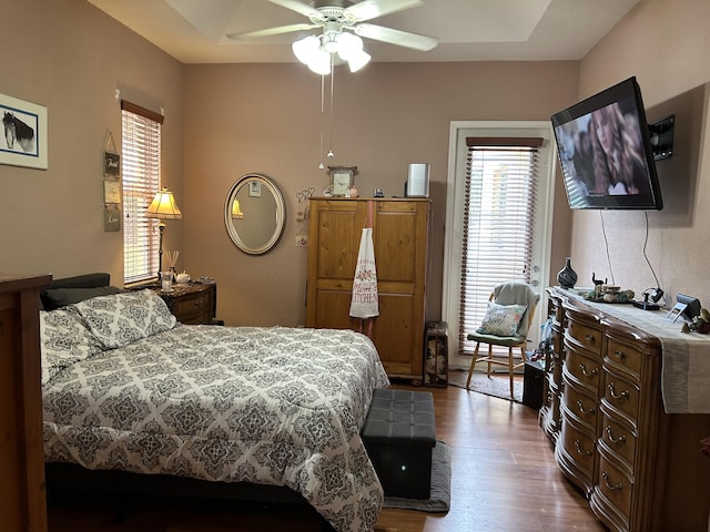 bedroom with hardwood / wood-style floors and ceiling fan