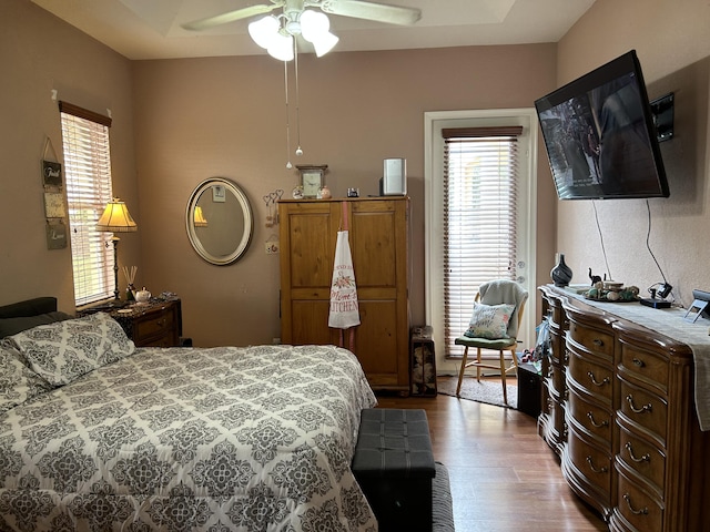 bedroom with ceiling fan and hardwood / wood-style floors