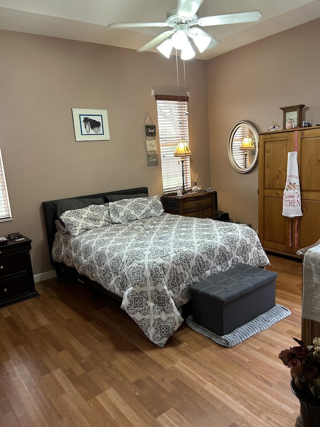 bedroom featuring hardwood / wood-style flooring and ceiling fan