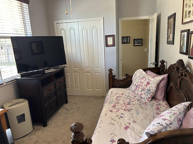 carpeted bedroom with multiple windows and a closet