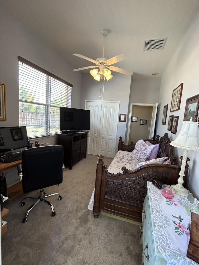 carpeted bedroom with ceiling fan, high vaulted ceiling, and a closet