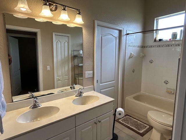 full bathroom featuring tile patterned floors, vanity, toilet, and tiled shower / bath