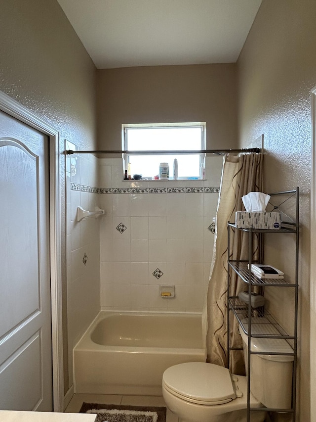 bathroom featuring toilet and shower / bathtub combination with curtain