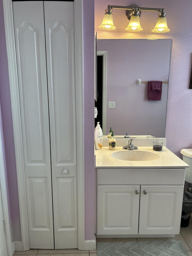 bathroom with tile patterned floors, vanity, and toilet