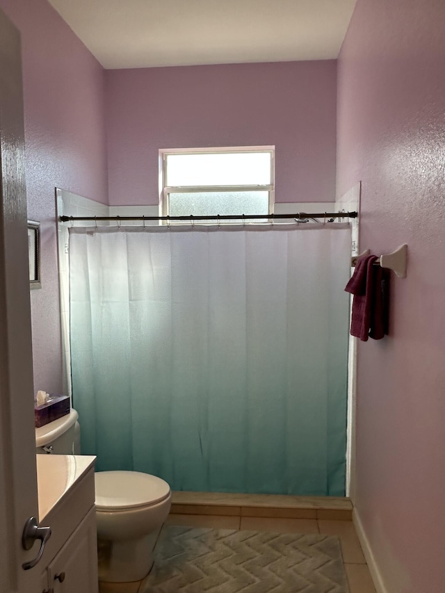 bathroom with tile patterned flooring, vanity, curtained shower, and toilet