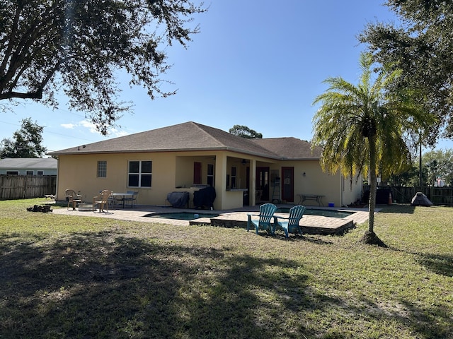 rear view of property with a yard and a patio