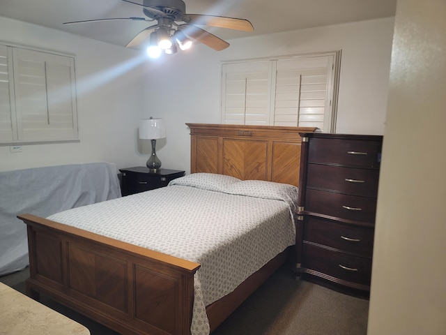 bedroom featuring dark colored carpet and ceiling fan