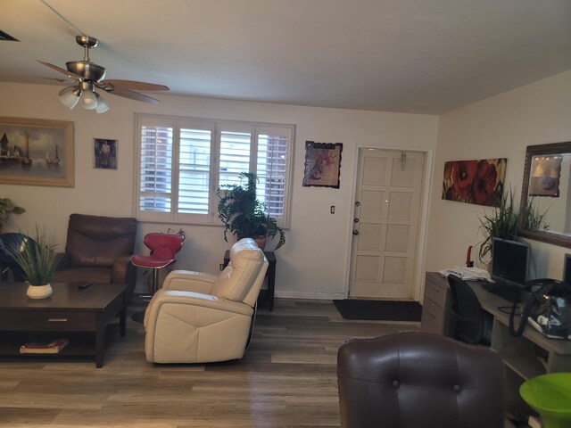 living room with ceiling fan and dark hardwood / wood-style flooring