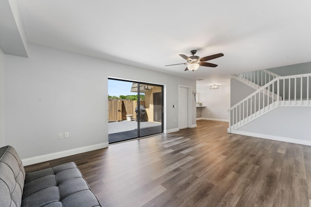 unfurnished living room with dark wood-type flooring and ceiling fan