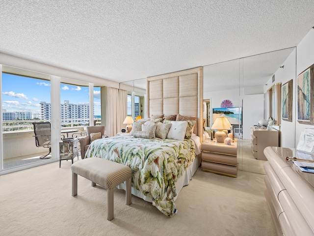 bedroom featuring light carpet and a textured ceiling