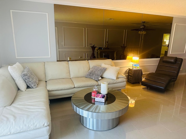 tiled living room featuring ceiling fan