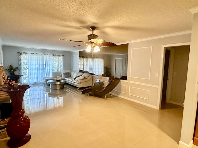 living room featuring light tile patterned flooring, a textured ceiling, ceiling fan, and ornamental molding