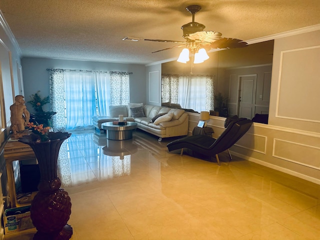 tiled living room featuring crown molding, a textured ceiling, and ceiling fan