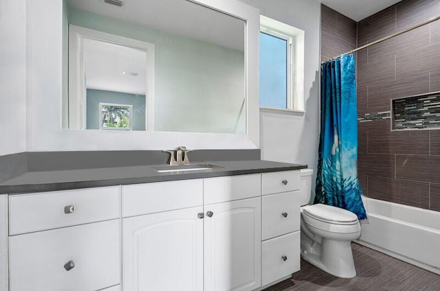 full bathroom with hardwood / wood-style flooring, vanity, toilet, and shower / bath combo with shower curtain