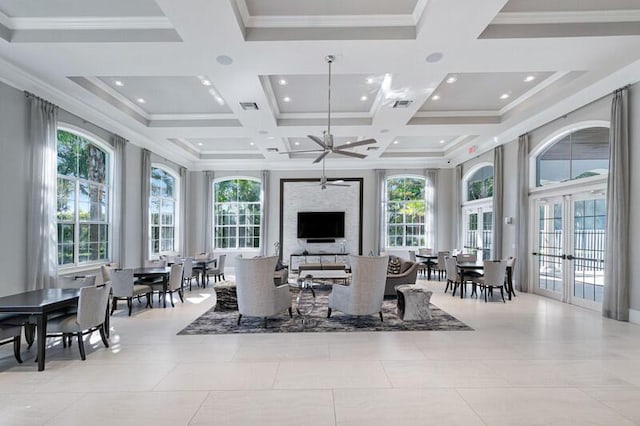 living room with french doors, ornamental molding, coffered ceiling, and a high ceiling