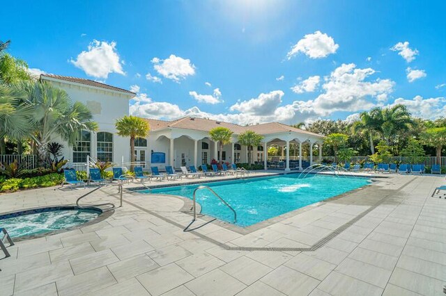 view of swimming pool featuring a patio area and a community hot tub