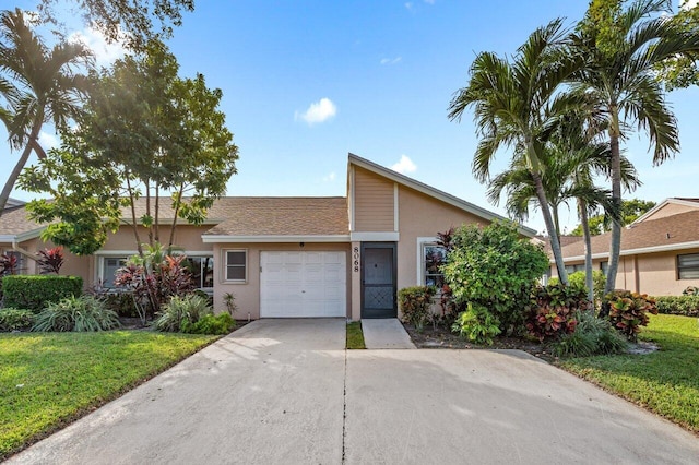 view of front facade with a front yard and a garage