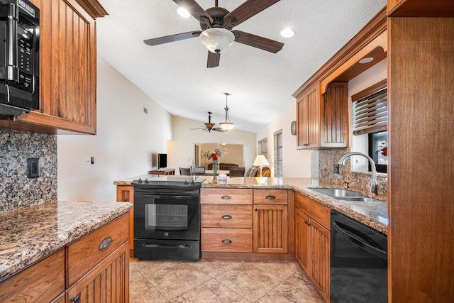 kitchen with sink, light stone counters, backsplash, lofted ceiling, and black appliances