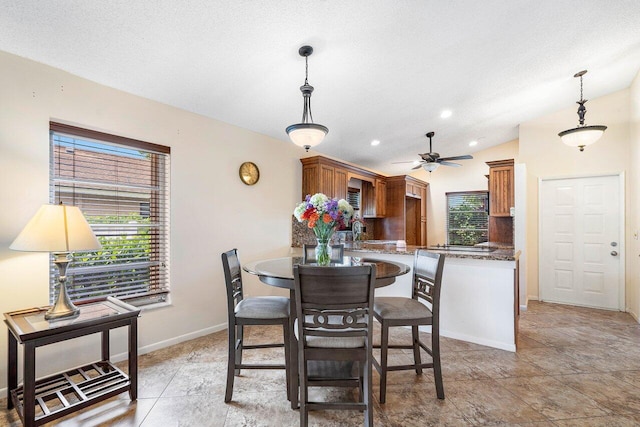 dining area featuring lofted ceiling, ceiling fan, a healthy amount of sunlight, and sink