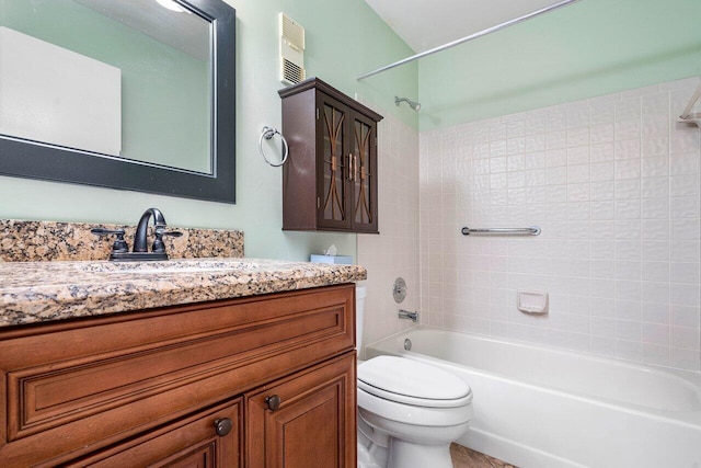 full bathroom with vanity, tiled shower / bath combo, and toilet