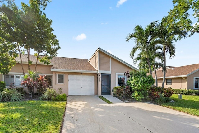 ranch-style house featuring a front yard and a garage