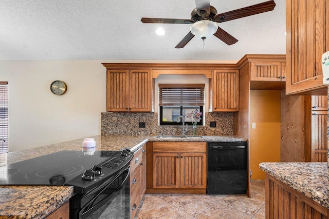 kitchen featuring decorative backsplash, a textured ceiling, sink, black appliances, and stone countertops